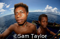 Local kids visit the dive deck. Kavieng PNG by Sam Taylor 